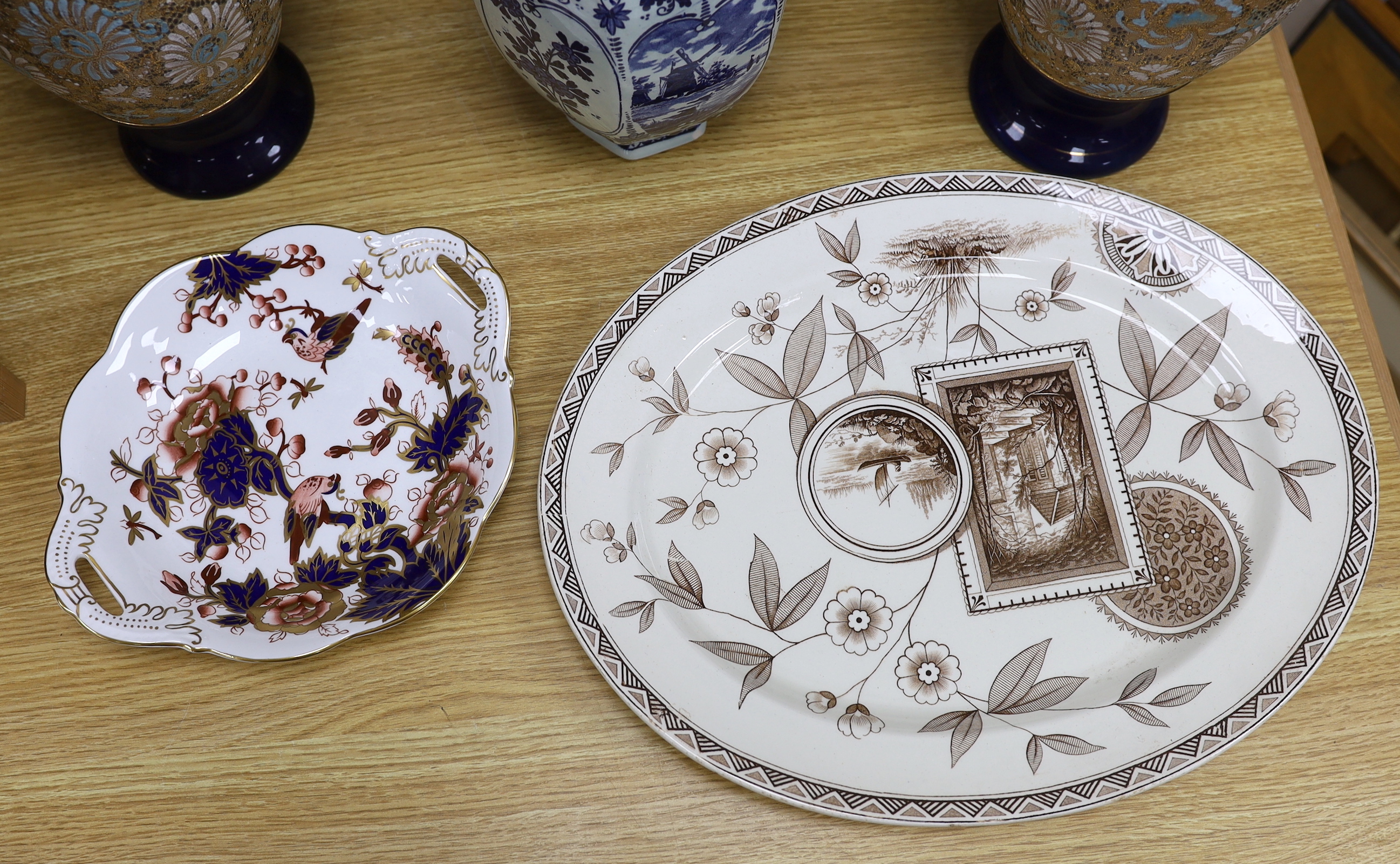 Seven ceramic pieces including a pair of Royal Doulton vases, Coalport dish and Delft jar and cover, 34cm high